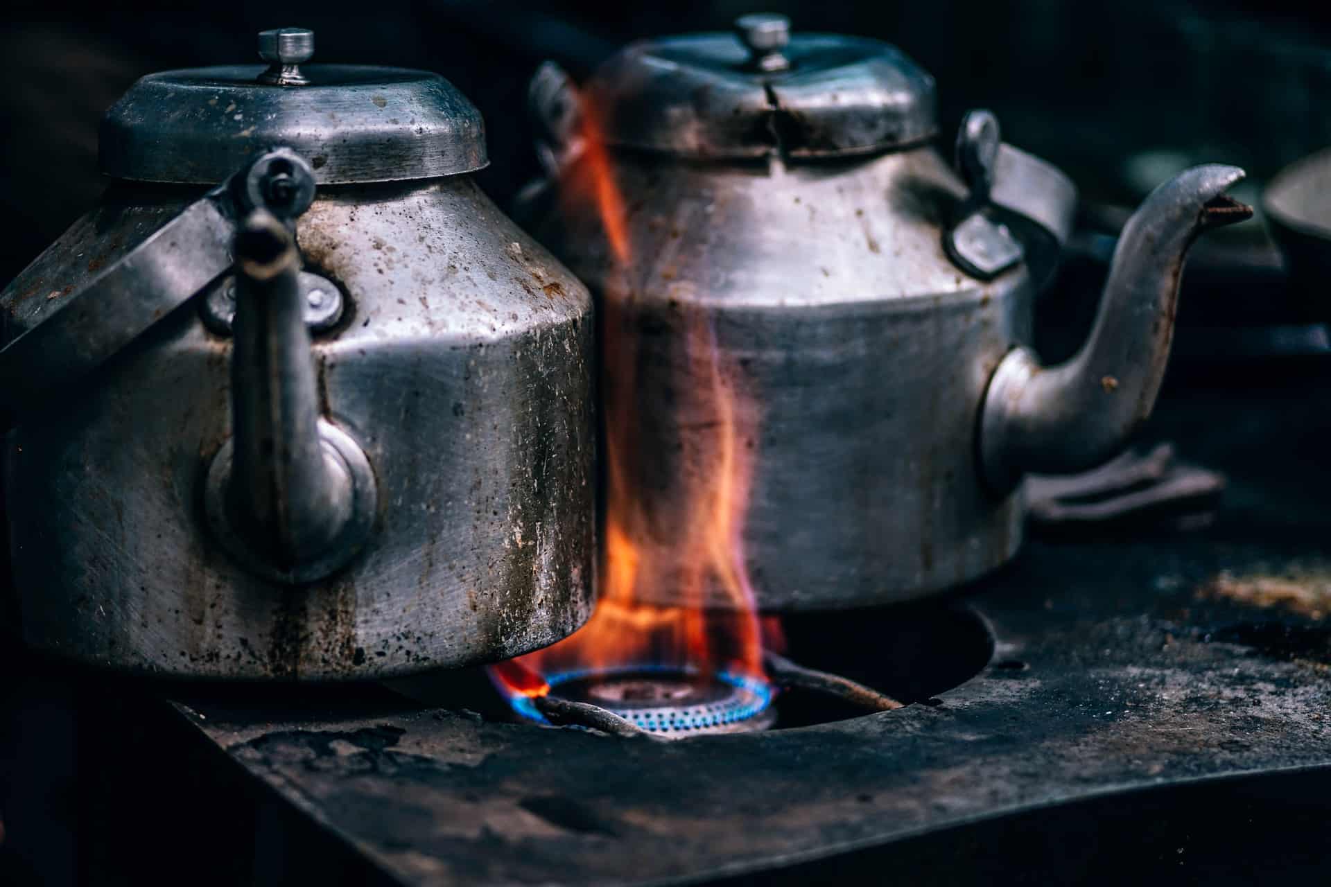 two kettles on gas stove