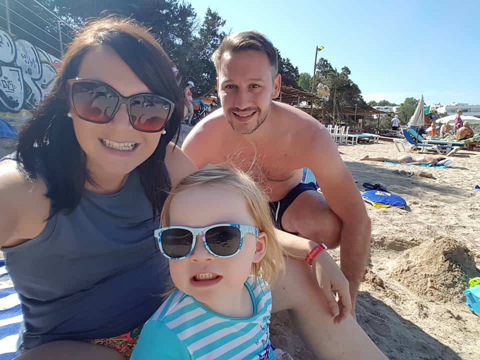 family of three on a beach