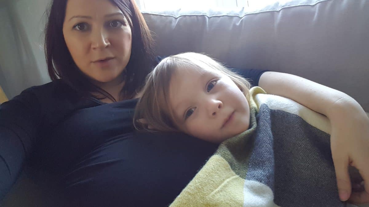 mum and daughter resting on sofa