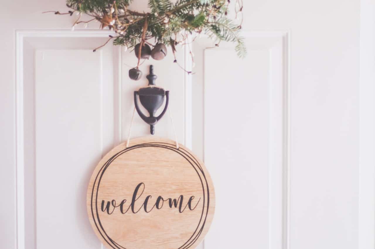 welcome sign on door of home