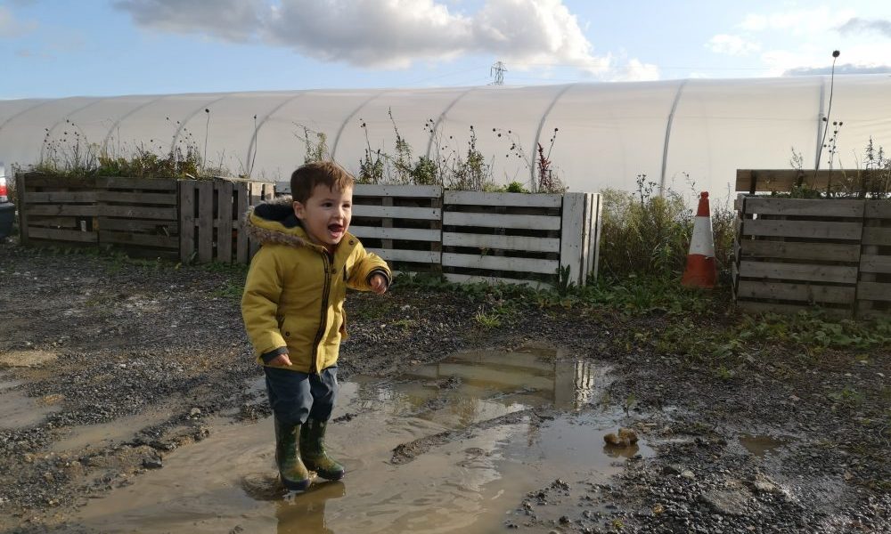 boy splashing in puddles