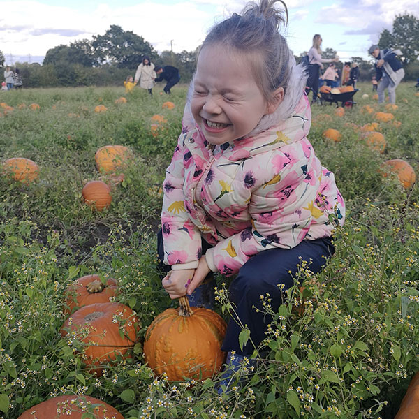 girl picking pumpkins