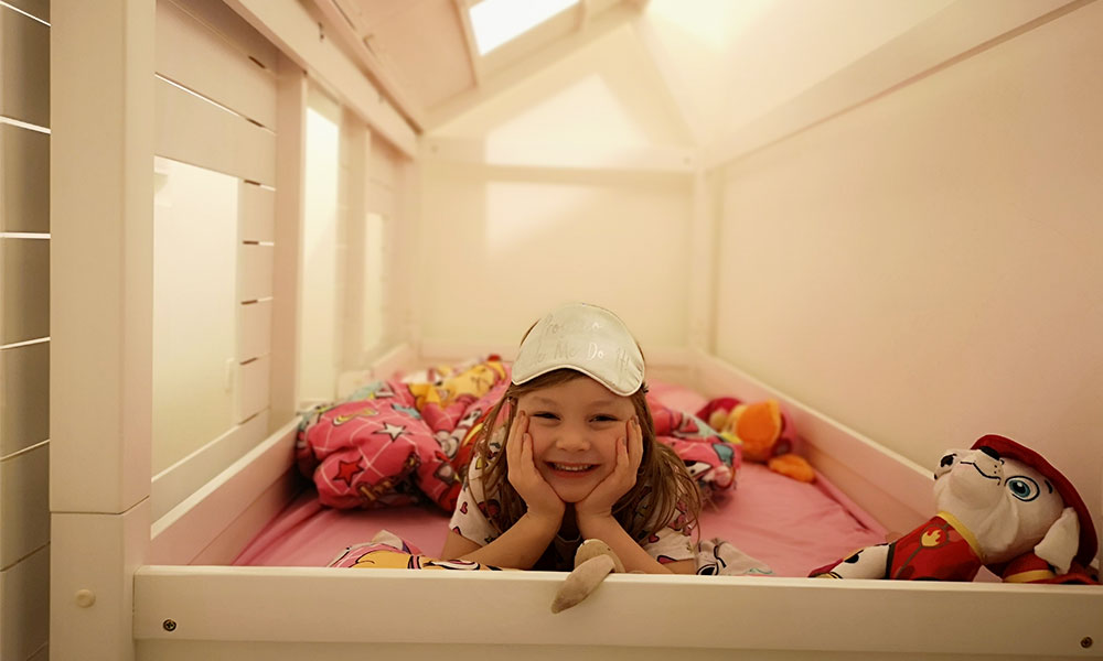 young girl posing in bed