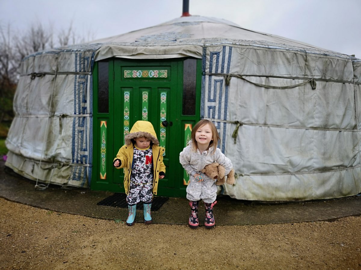 Two children outside a yurt