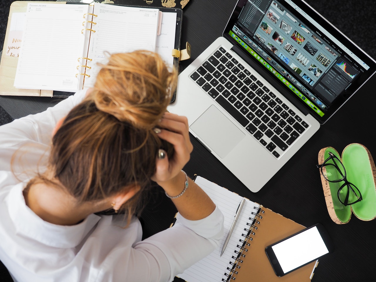 Lady with head in hands at computer