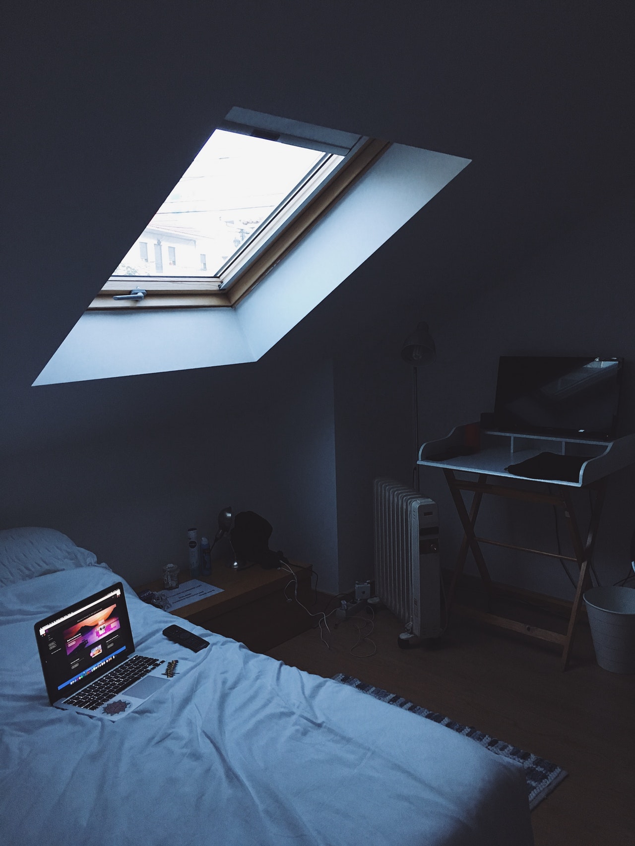 Computer on bed in bedroom