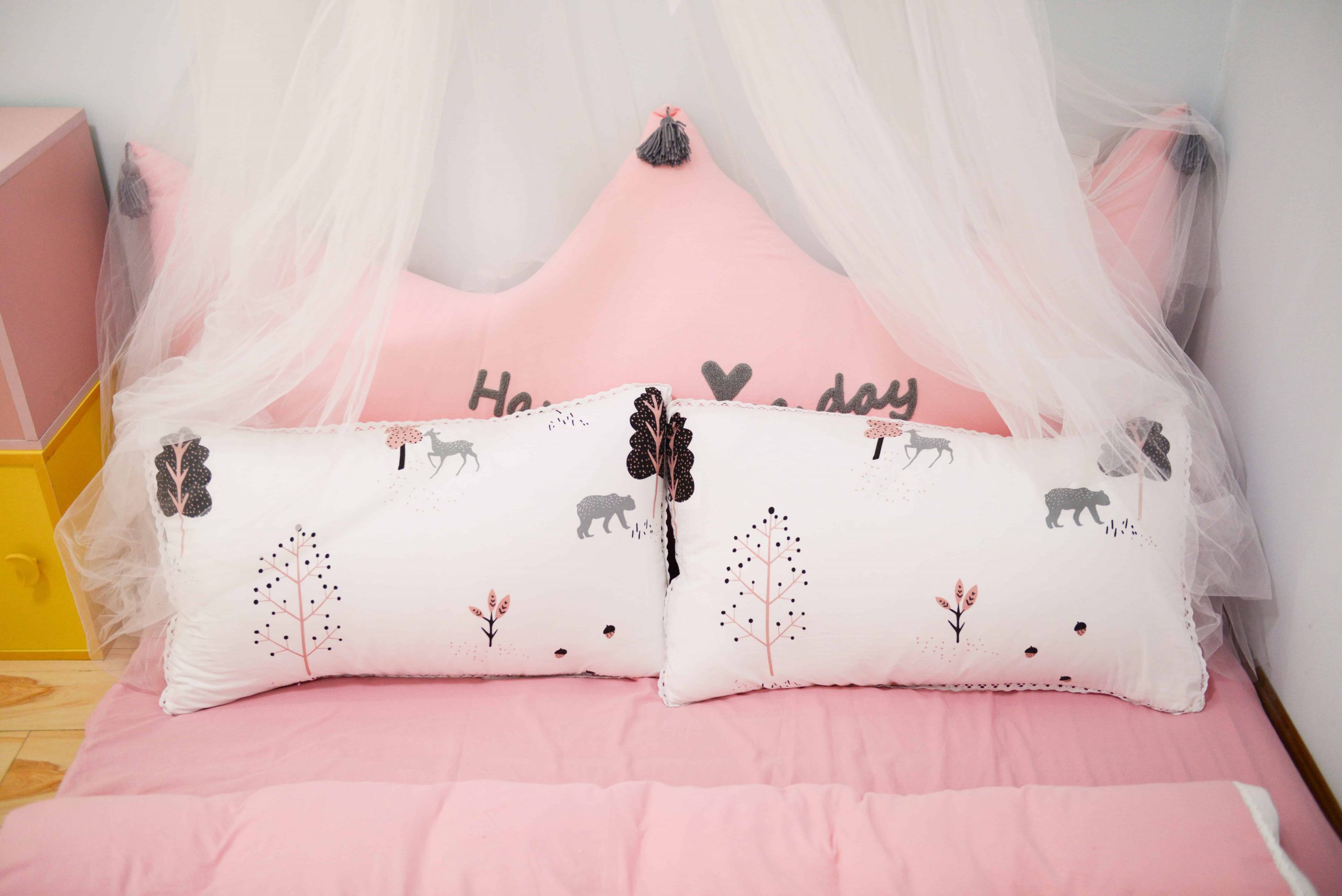two pillows on a pink bed