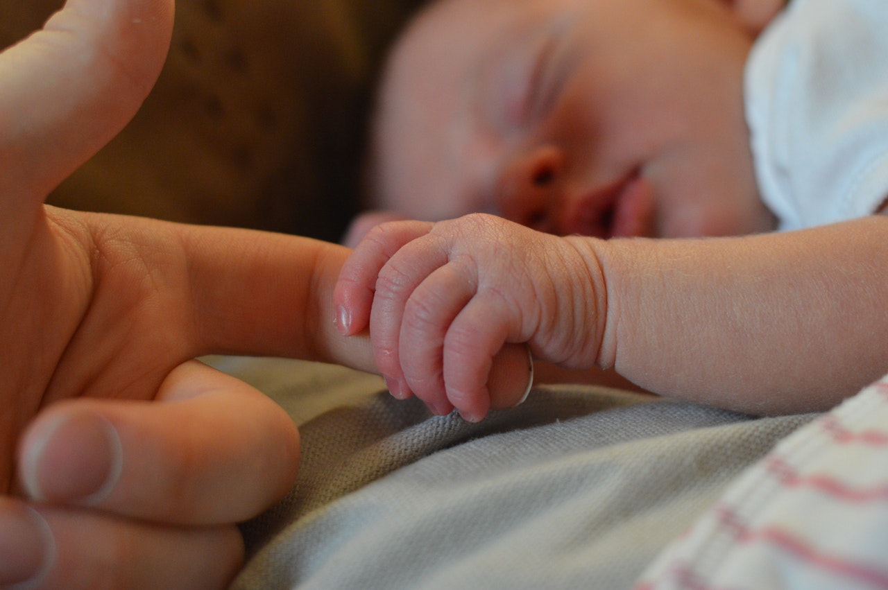 baby holding finger