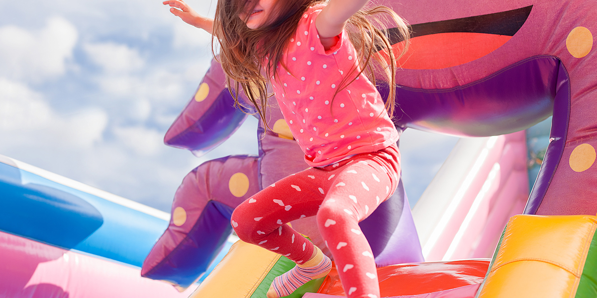 young girl jumping on bouncy castle