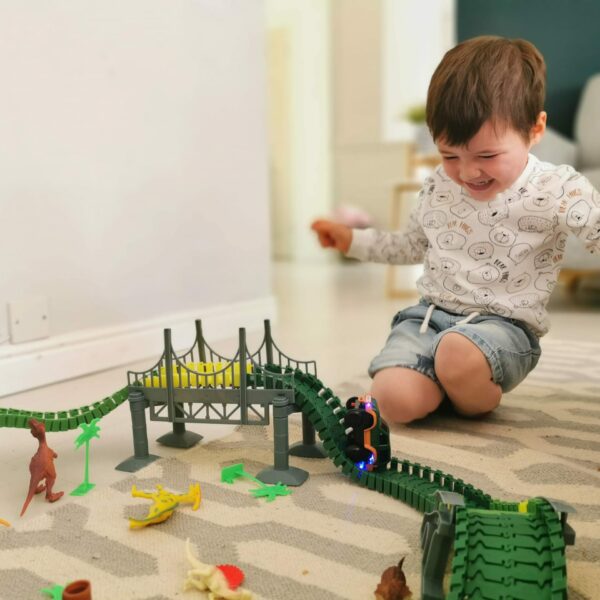 baby boy playing with train track