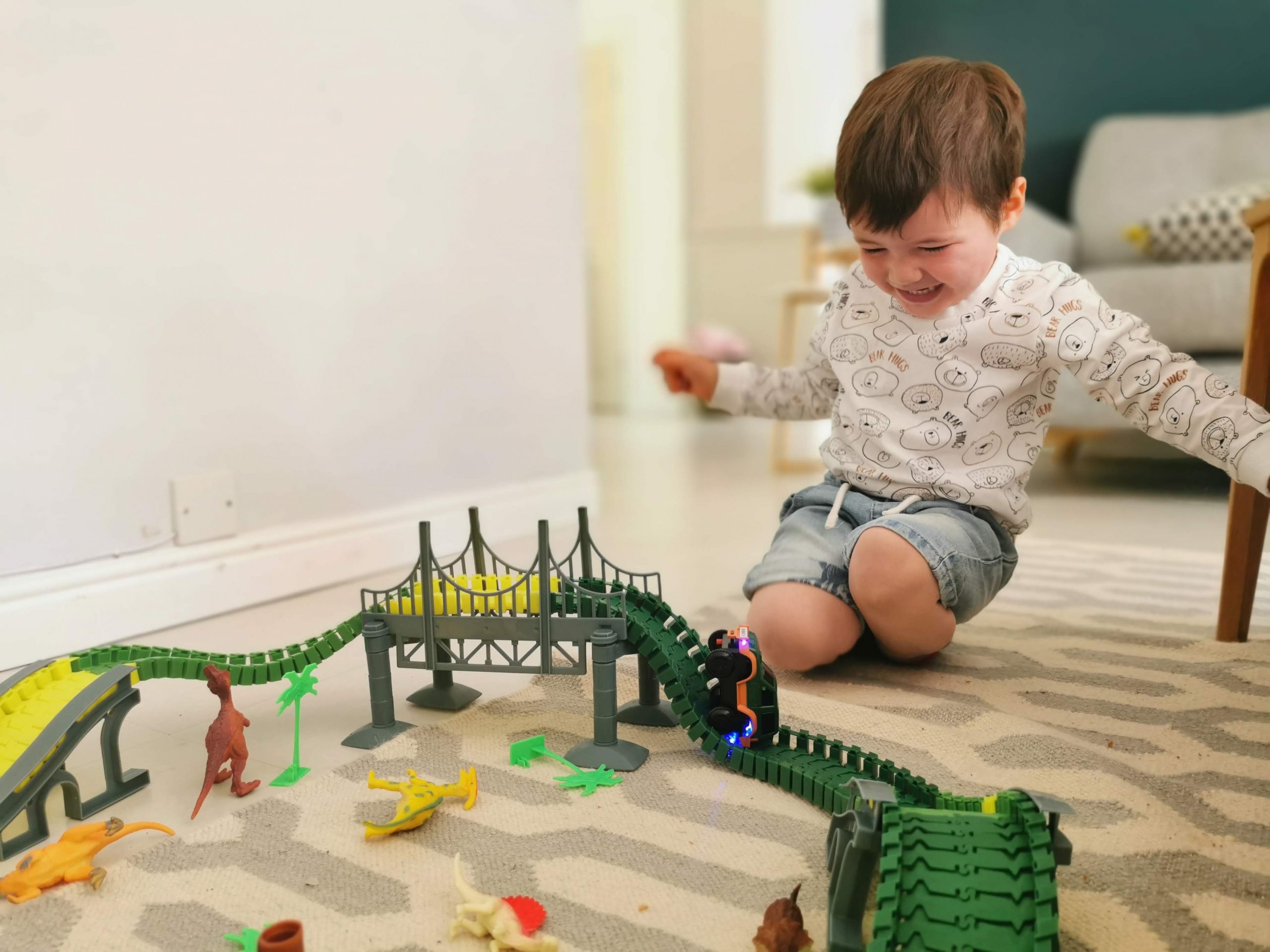 baby boy playing with train track