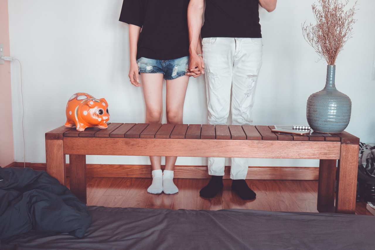 man and woman holding hands by coffee table