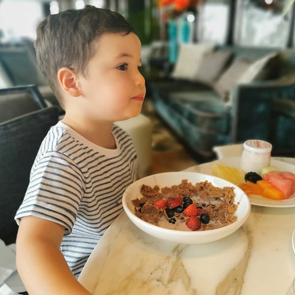 boy eating breakfast in a restaurant