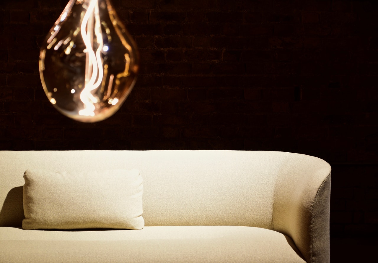 cream sofa with lighbulb in forefront