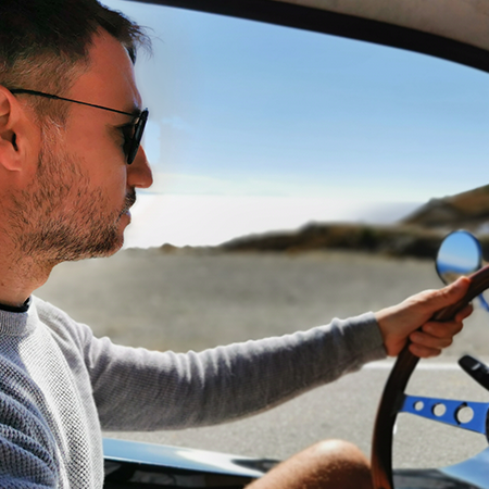 man driving a beach buggy