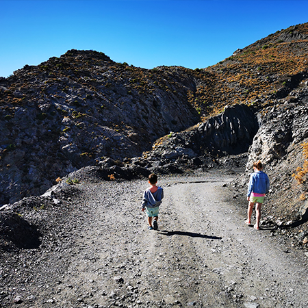 two children walking down mountain side