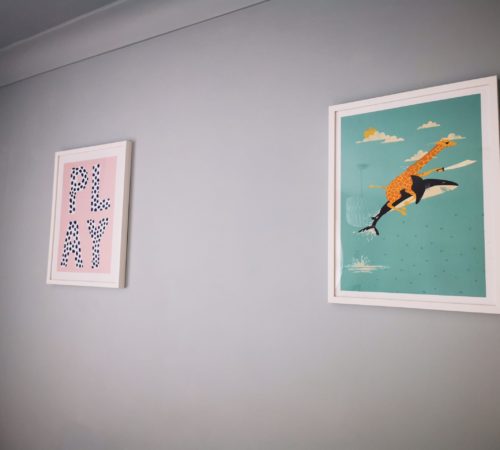 two colourful pictures on playroom wall