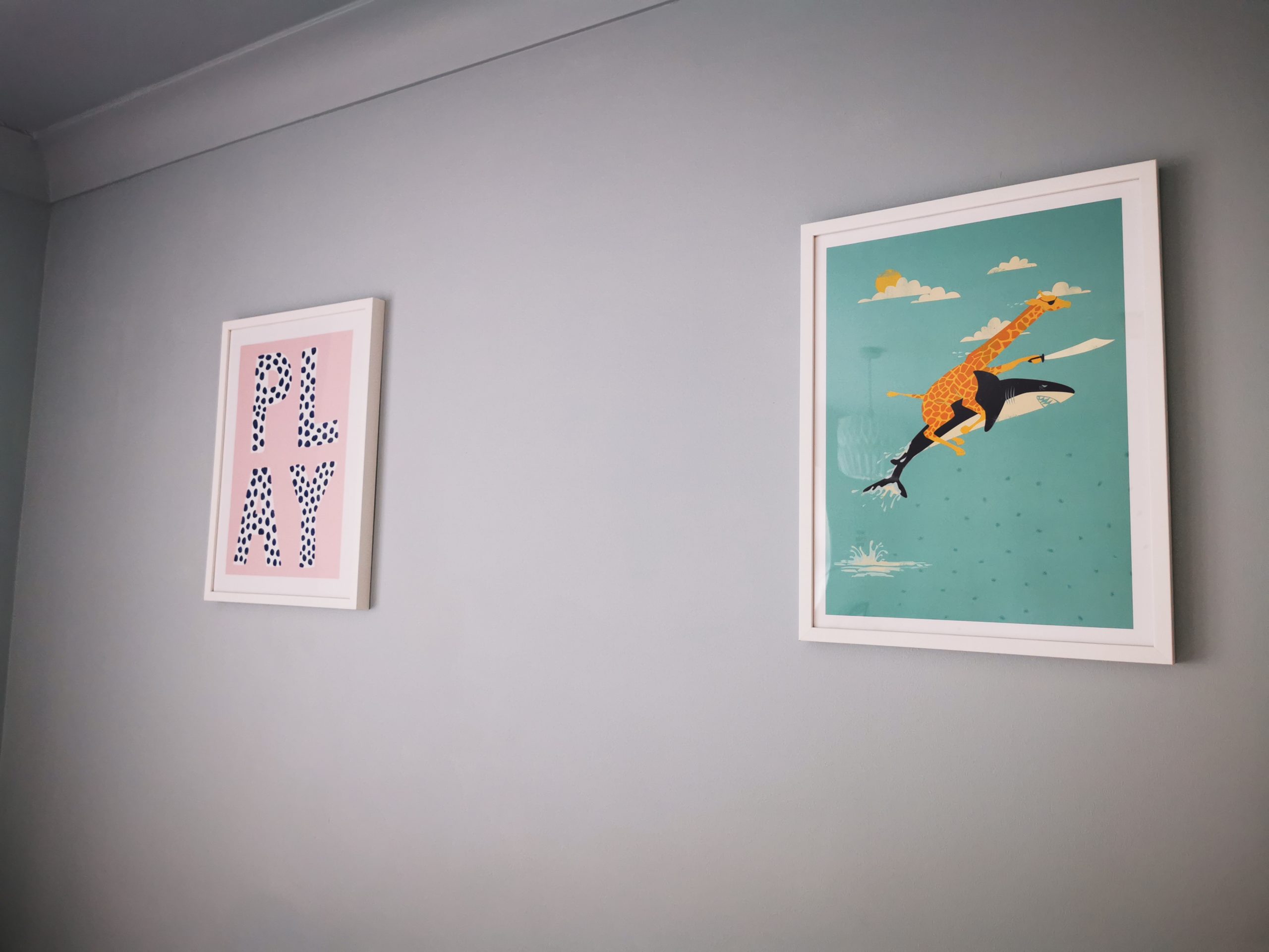 two colourful pictures on playroom wall
