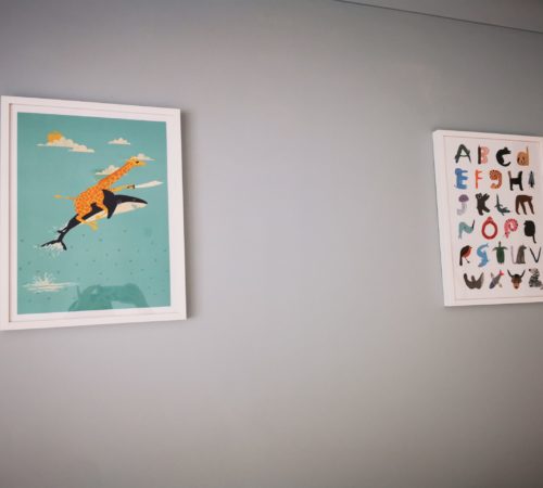 two colourful pictures on playroom wall