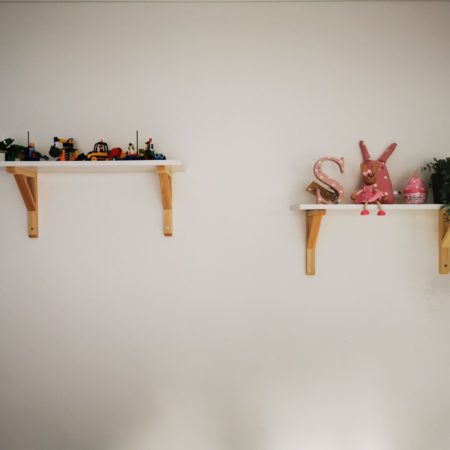 two shelves with toys on