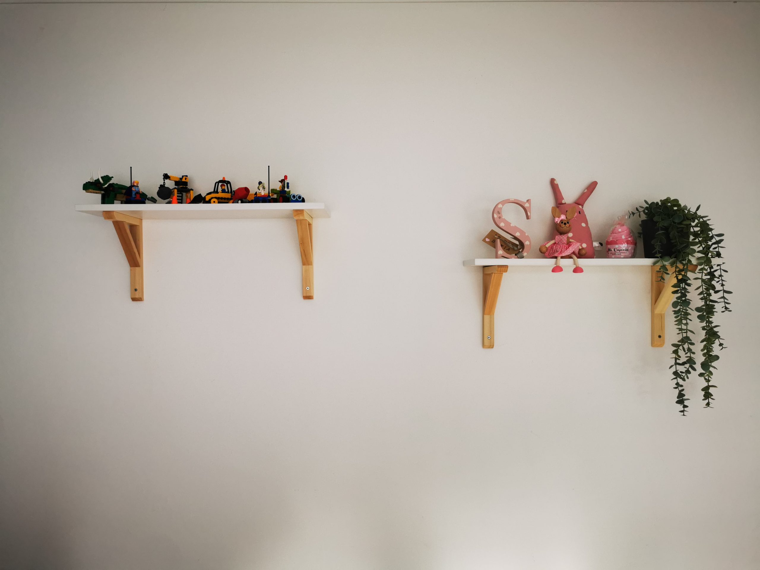 two shelves with toys on