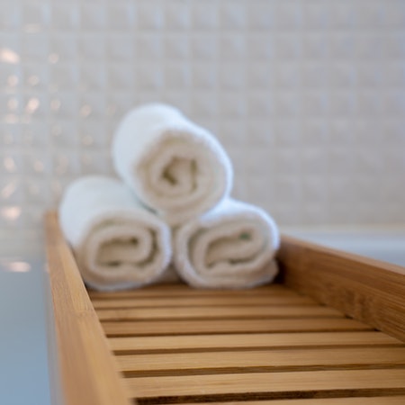 TOWELS ROLLED UP ON A BATH TRAY
