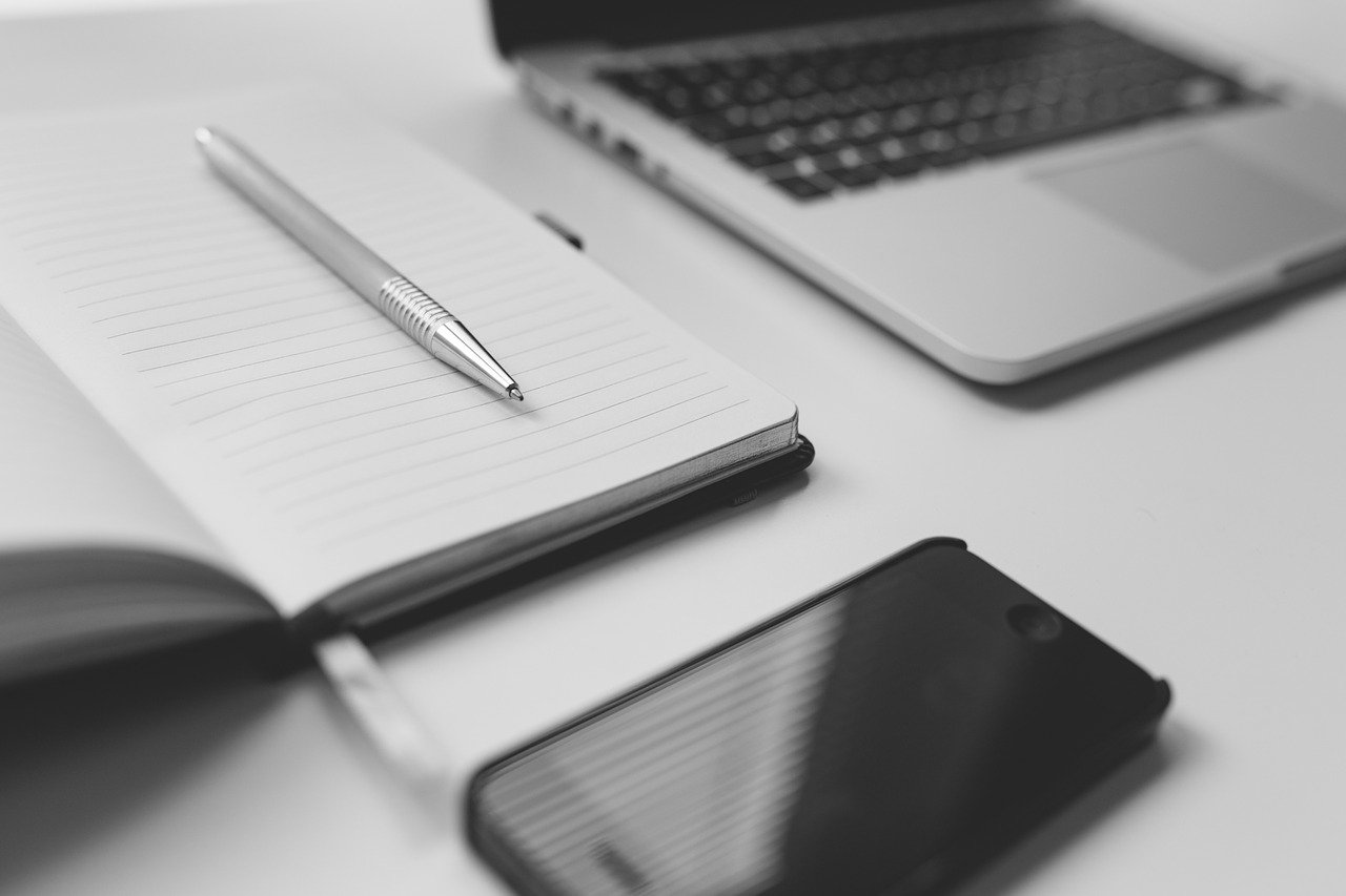 desk with phone and ipad