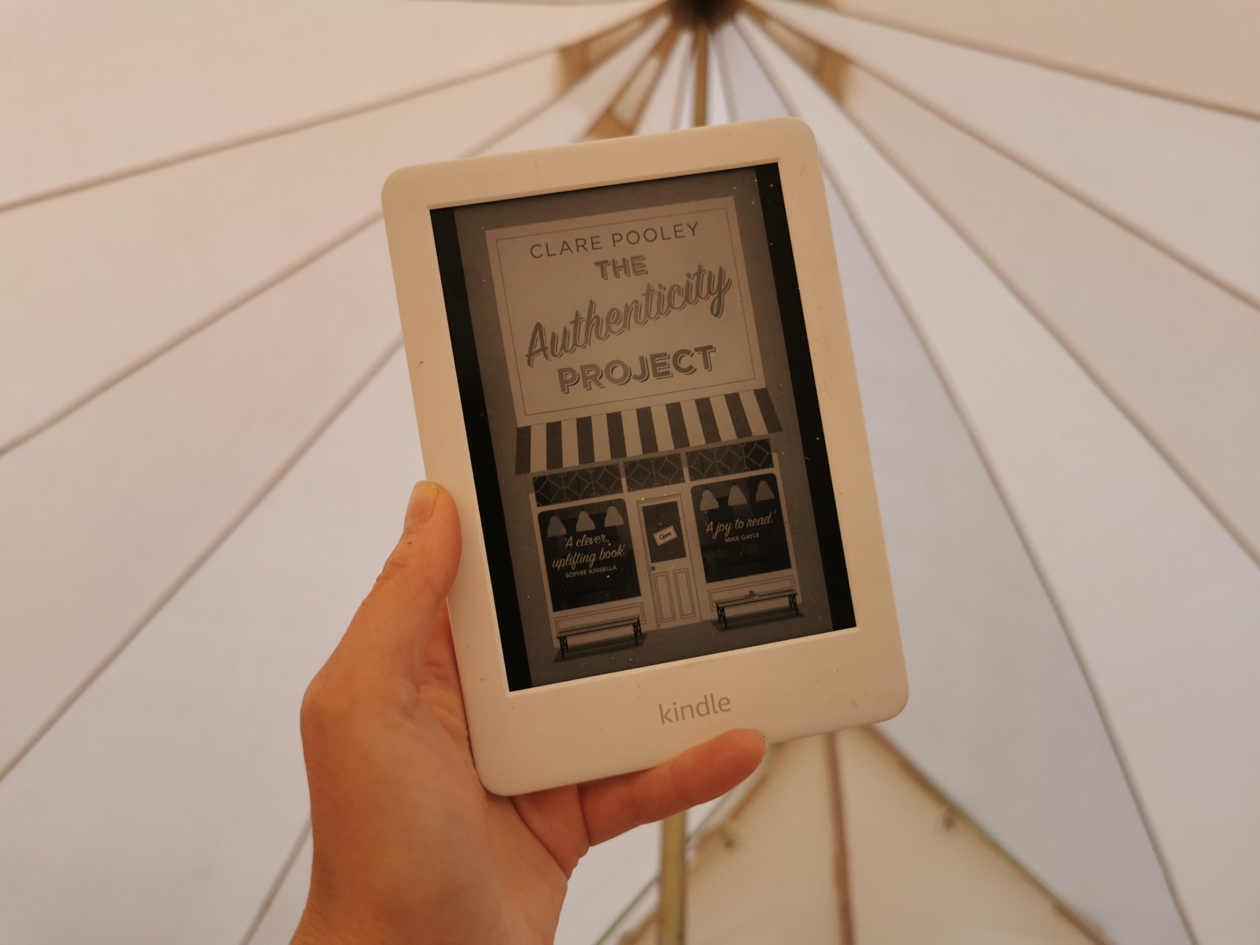 kindle book being held up in tent