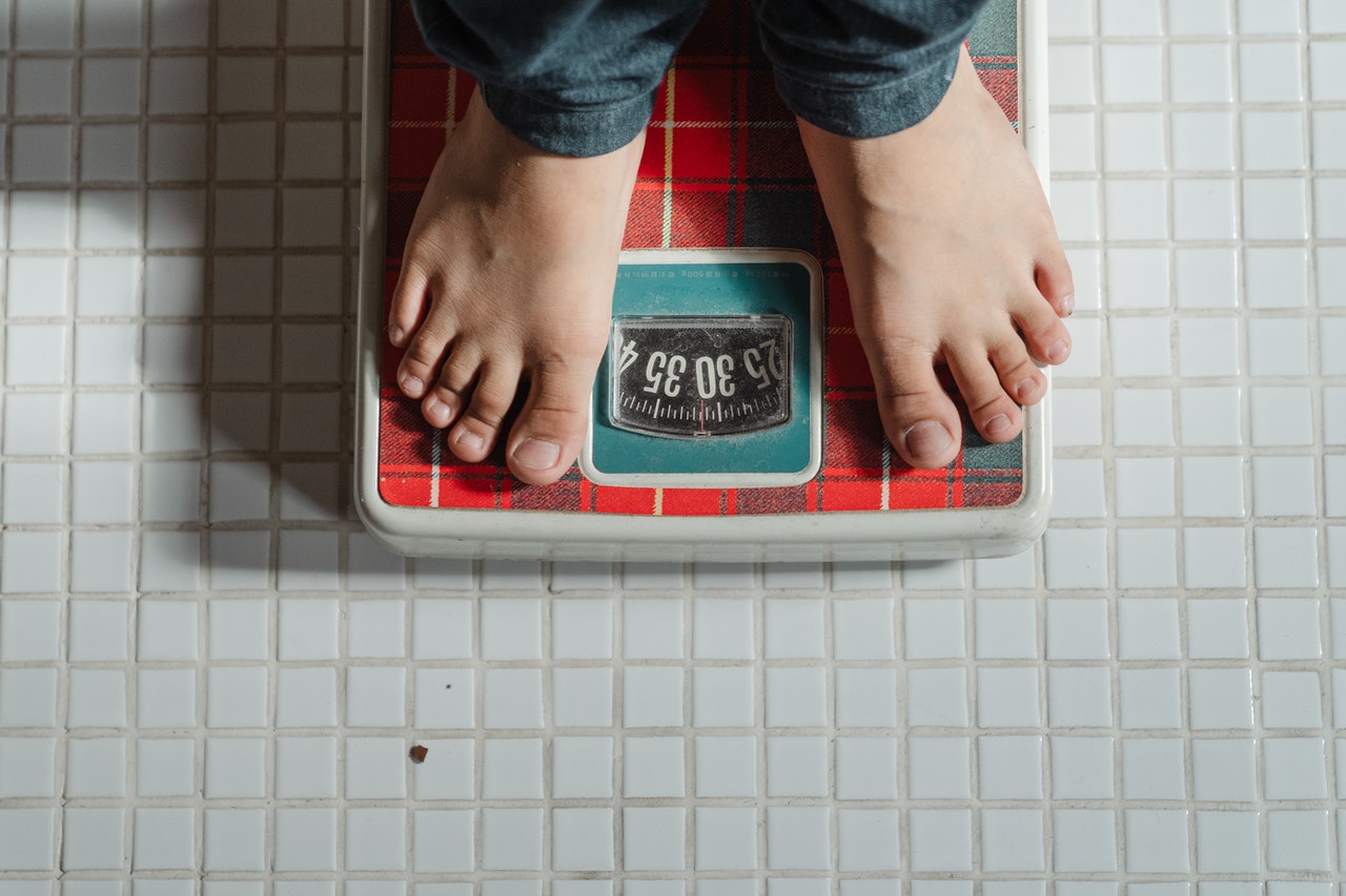 Lady standing on weighing scales